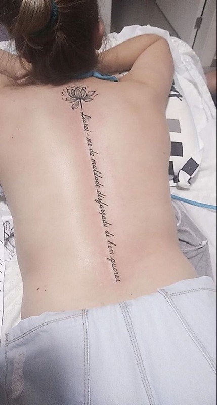 lotus word back tattoo
